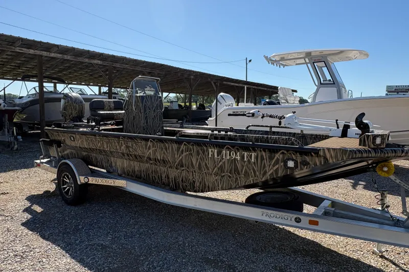 Slide: The Image of 2022 Prodigy 18' PRO VS boat with camouflage design on a trailer. - 3