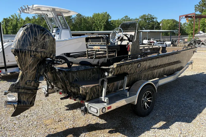 Slide: The Image of 2022 Prodigy 18' PRO VS boat with camouflage design on a trailer. - 7