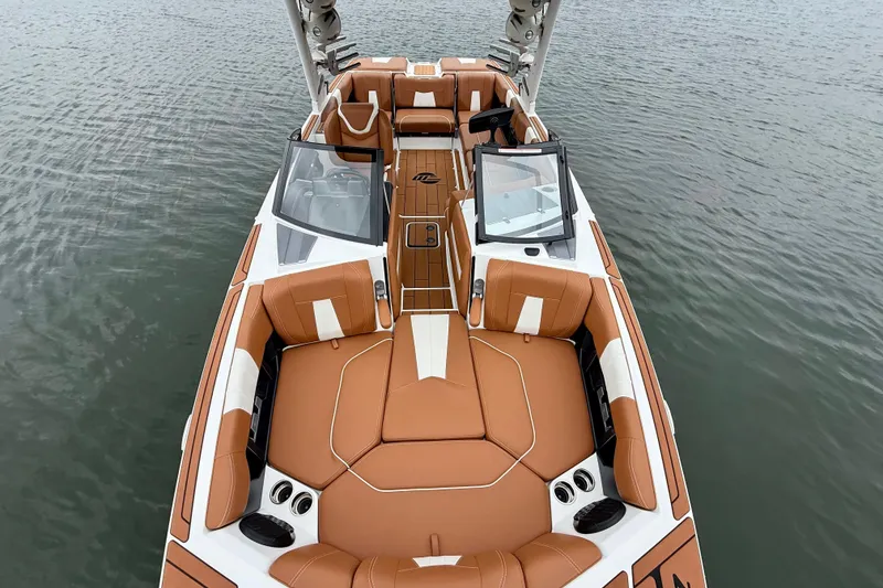 Slide: The Image of 2023 Malibu Wakesetter 24 MXZ boat with luxurious tan seating on calm water. - 20
