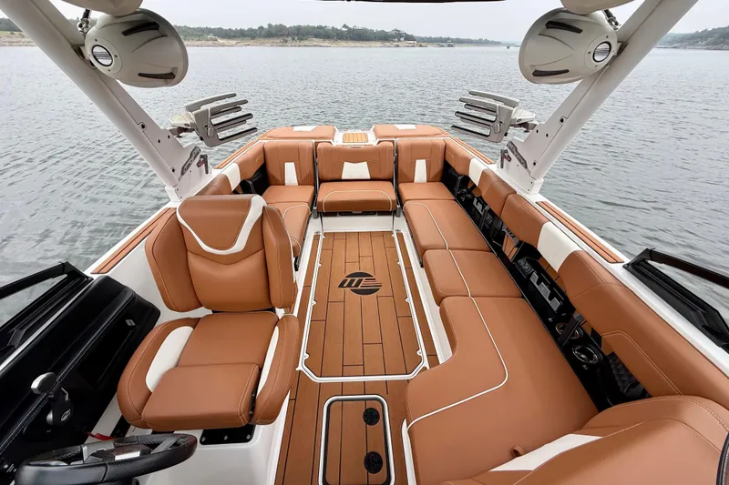 Slide: The Image of 2023 Malibu Wakesetter 24 MXZ interior with luxurious tan seating on a lake. - 21
