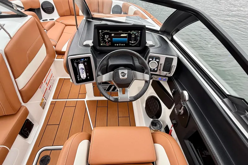 Slide: The Image of 2023 Malibu Wakesetter 24 MXZ boat interior with modern dashboard and leather seating. - 24