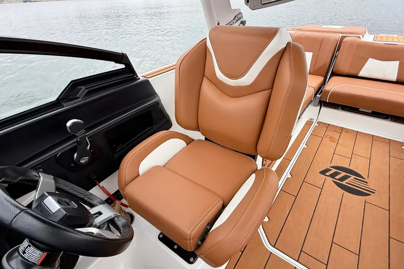 Slide: The Image of 2023 Malibu Wakesetter 24 MXZ interior with luxurious tan seating and sleek steering wheel. - 26