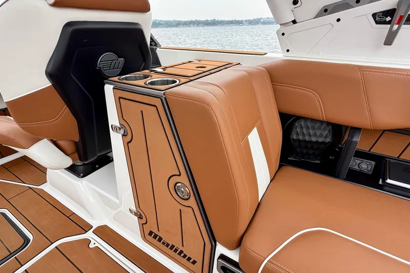 Slide: The Image of 2023 Malibu Wakesetter 24 MXZ interior with tan leather seats and cup holders. - 27