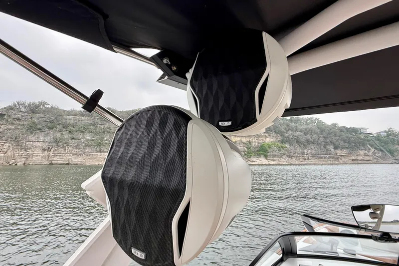 Slide: The Image of 2023 Malibu Wakesetter 24 MXZ boat speakers with scenic lake backdrop. - 31