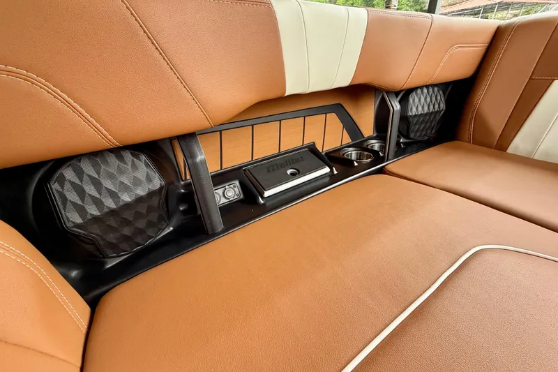 Slide: The Image of 2023 Malibu Wakesetter 24 MXZ interior with brown leather seats and integrated speakers. - 33