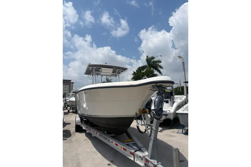 The Image of 1998 Pursuit 2870 Center Console boat on trailer under a partly cloudy sky. - 1