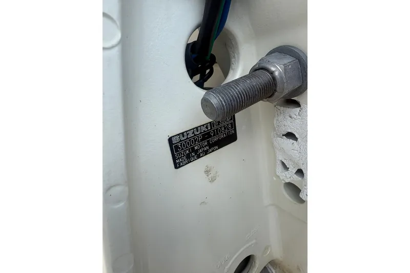 Slide: The Image of Close-up of a Suzuki motor label on a 1998 Pursuit 2870 Center Console boat. - 12