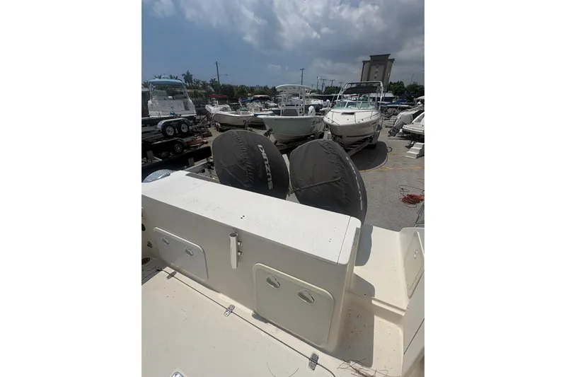 Slide: The Image of 1998 Pursuit 2870 Center Console boat in a marina, surrounded by other vessels. - 15