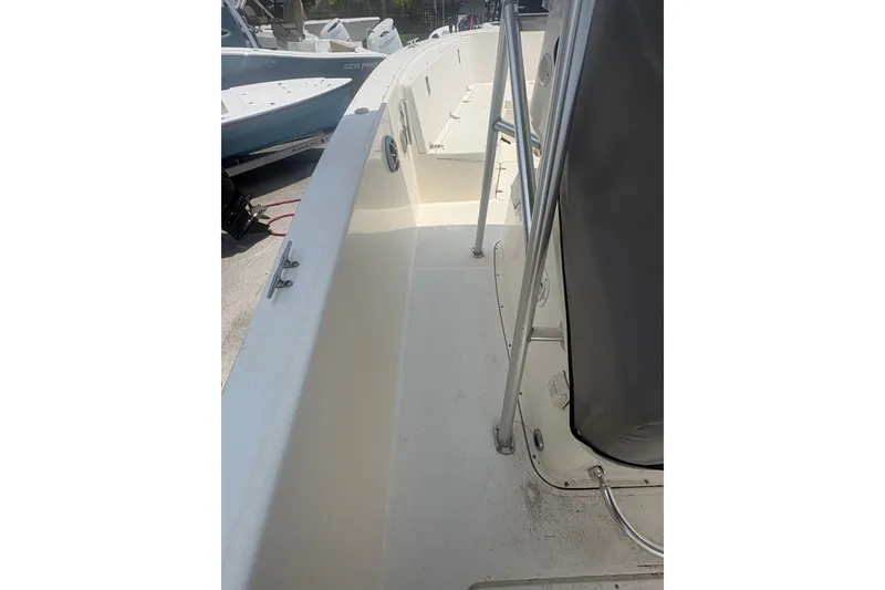 Slide: The Image of 1998 Pursuit 2870 Center Console boat deck, featuring spacious walkways and sturdy railings. - 19
