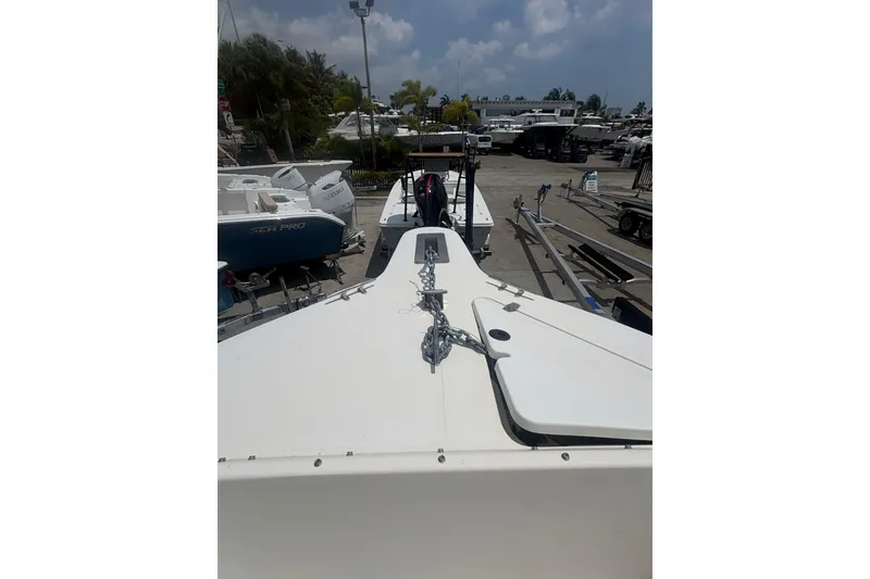 Slide: The Image of 1998 Pursuit 2870 Center Console boat on trailer in marina setting. - 24