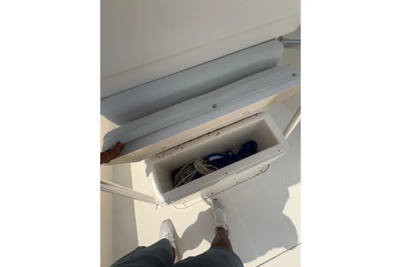 Slide: The Image of 1998 Pursuit 2870 Center Console storage compartment with ropes inside. - 27