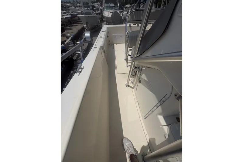 Slide: The Image of 1998 Pursuit 2870 Center Console boat interior with seating and storage compartments. - 28