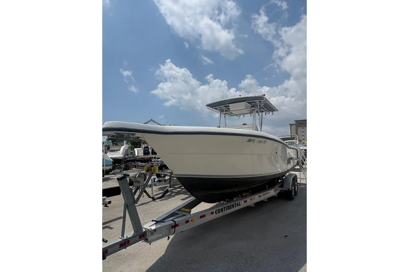 Slide: The Image of 1998 Pursuit 2870 Center Console boat on trailer under a cloudy sky. - 3