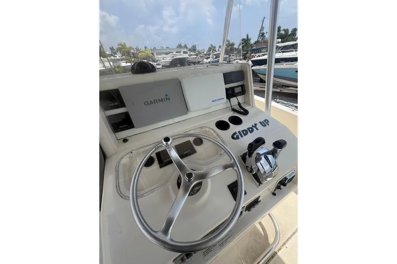 Slide: The Image of 1998 Pursuit 2870 Center Console helm with Garmin navigation and "Giddy Up" text. - 30