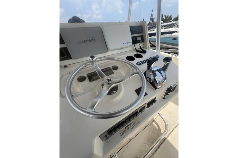 Slide: The Image of 1998 Pursuit 2870 Center Console helm with Garmin navigation and control panel. - 31