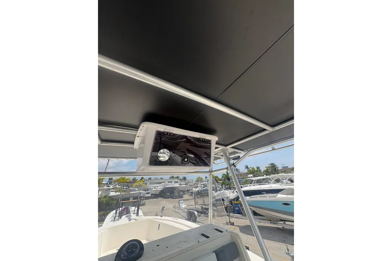 Slide: The Image of 1998 Pursuit 2870 Center Console boat interior with overhead electronics and marina view. - 32
