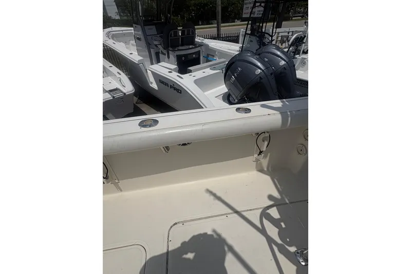 Slide: The Image of 1998 Pursuit 2870 Center Console boat with dual Yamaha engines, docked outdoors. - 34