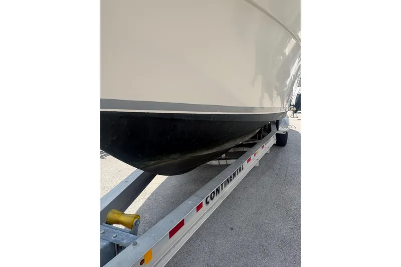 Slide: The Image of 1998 Pursuit 2870 Center Console boat on a Continental trailer. - 5