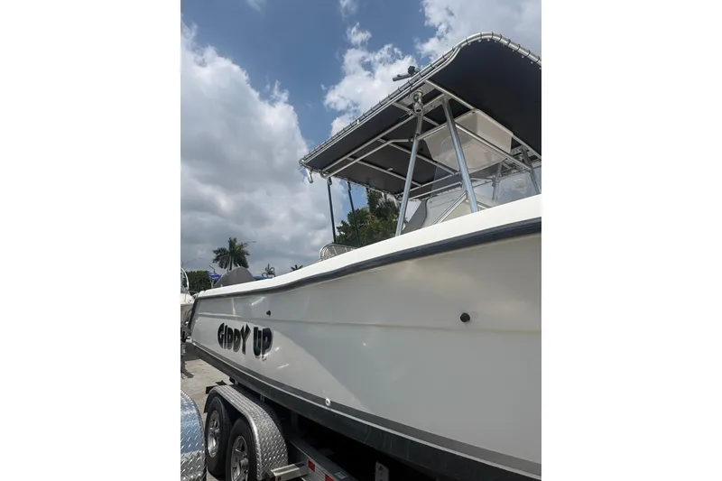 Slide: The Image of 1998 Pursuit 2870 Center Console boat on trailer under cloudy sky. - 8