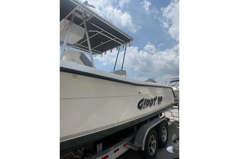 Slide: The Image of 1998 Pursuit 2870 Center Console boat on trailer under cloudy sky. - 9