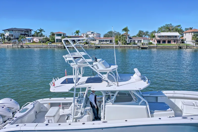 Slide: The Image of 2015 Yellowfin 42 Offshore boat with triple outboard engines on the water. - 1