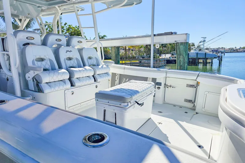 Slide: The Image of 2015 Yellowfin 42 Offshore boat interior with luxurious seating and waterfront view. - 11