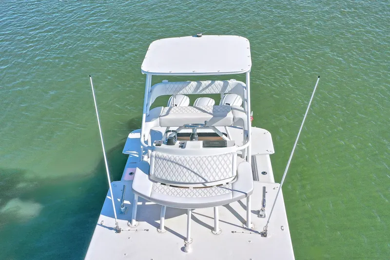 Slide: The Image of 2015 Yellowfin 42 Offshore boat on calm water near coastal homes. - 7