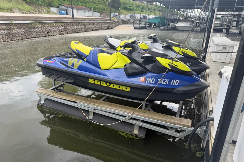 The Image of 2020 Sea-Doo Wake 170 jet skis docked on a lift at a marina. - 0