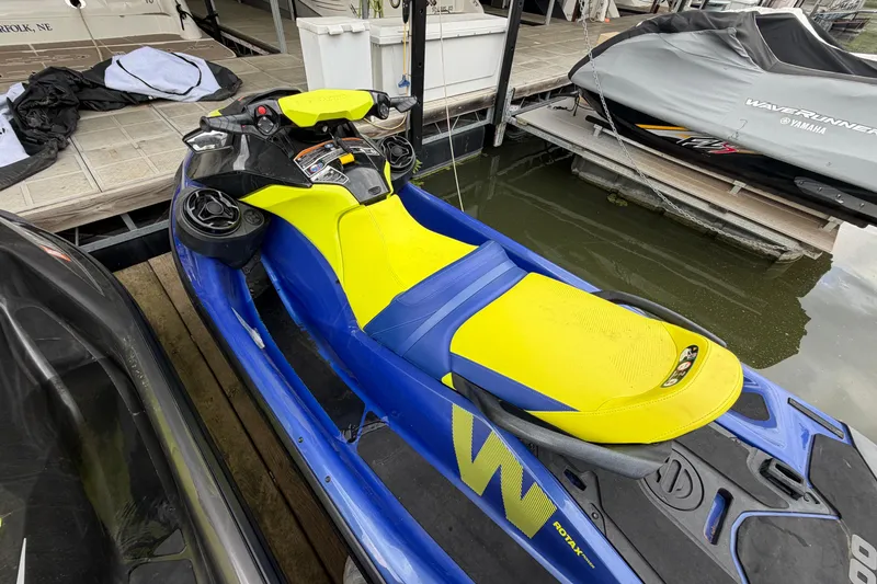 Slide: The Image of 2020 Sea-Doo Wake 170 jet ski with vibrant yellow and blue design docked by the water. - 3
