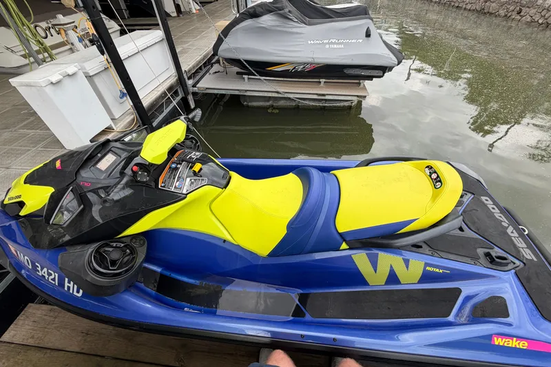 Slide: The Image of 2020 Sea-Doo Wake 170 jet ski docked, featuring vibrant yellow and blue design. - 4