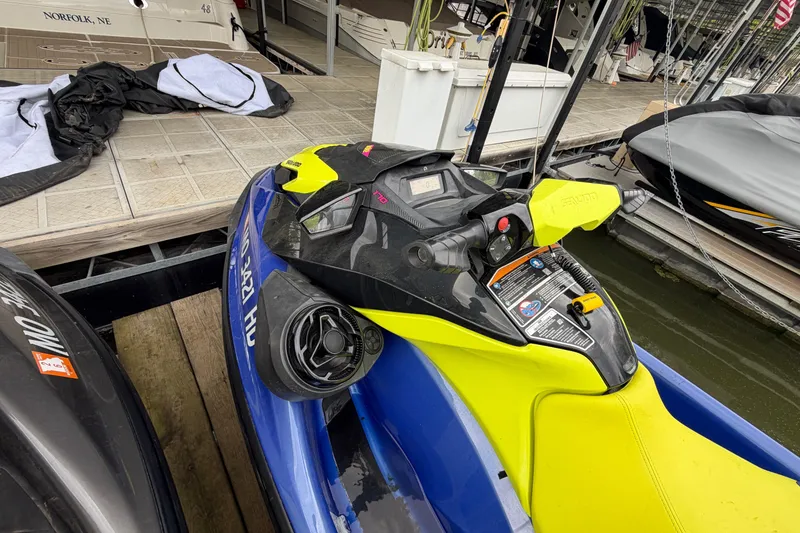 Slide: The Image of 2020 Sea-Doo Wake 170 jet ski docked at marina, featuring vibrant yellow and blue design. - 6