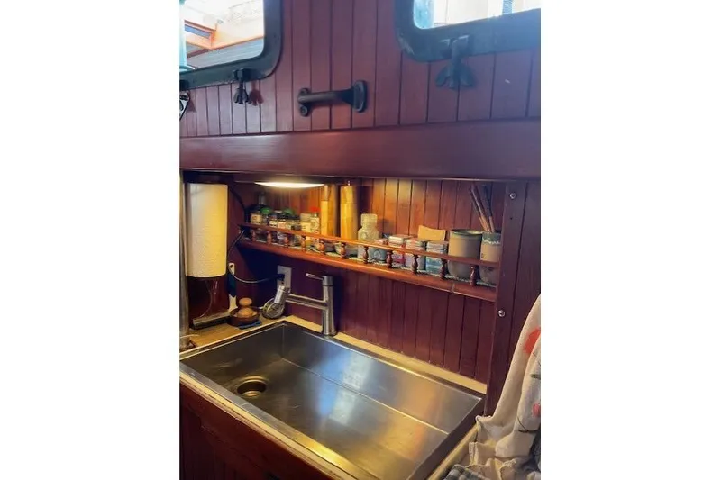 Slide: The Image of 1983 Vagabond 42 yacht kitchen with stainless steel sink and spice rack. - 10