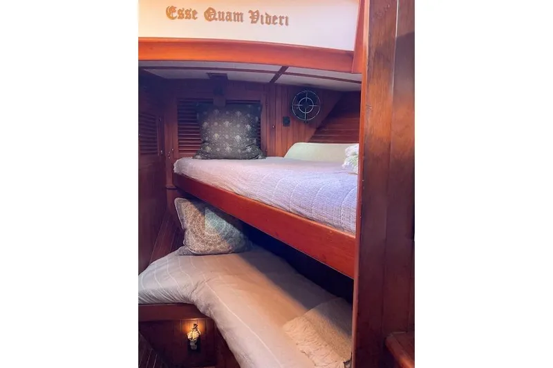 Slide: The Image of Cozy 1983 Vagabond 42 yacht cabin with wooden bunk beds and nautical decor. - 12