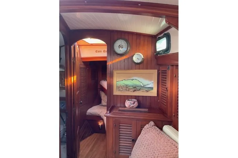 Slide: The Image of Interior of 1983 Vagabond 42 sailboat with wood paneling and nautical decor. - 17