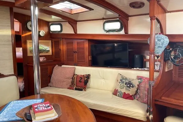 Slide: The Image of Cozy interior of 1983 Vagabond 42 sailboat with wooden furnishings and comfortable seating. - 7