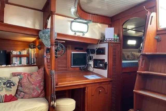 Slide: The Image of Cozy interior of a 1983 Vagabond 42 sailboat with wooden furnishings and navigation equipment. - 8