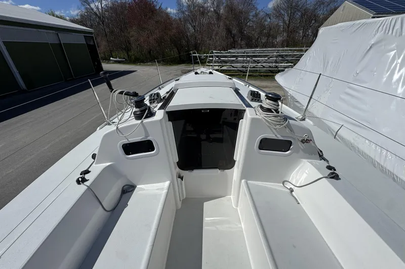 Slide: The Image of 2011 J Boats J/95 sailboat cockpit with winches and ropes, docked outdoors. - 14