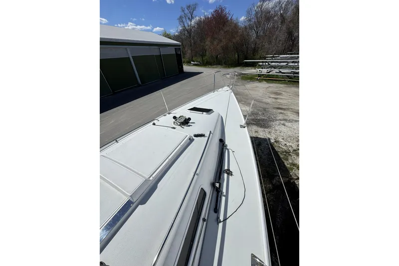 Slide: The Image of 2011 J Boats J/95 sailboat deck view, parked near storage facility. - 15