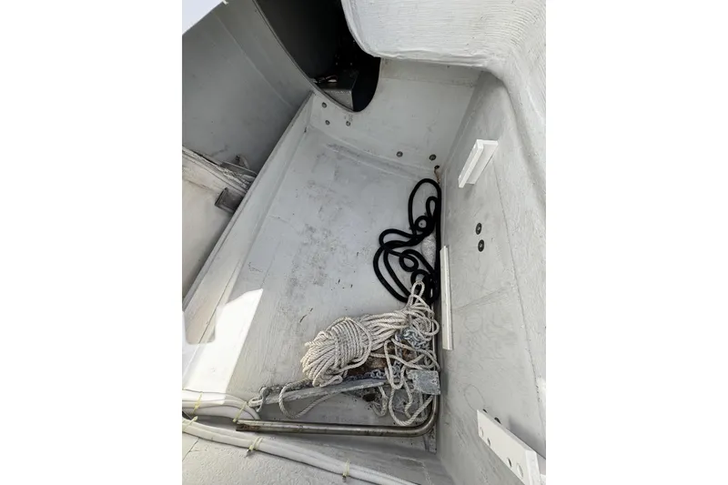 Slide: The Image of Interior view of a 2011 J Boats J/95 sailboat, featuring ropes and equipment. - 19
