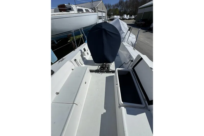 Slide: The Image of 2011 J Boats J/95 sailboat cockpit with covered engine and open storage compartments. - 21