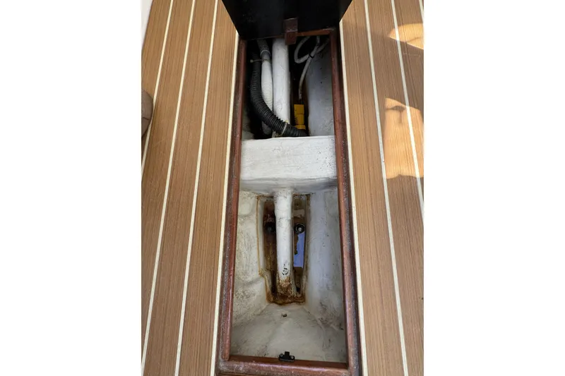 Slide: The Image of 2011 J Boats J/95 interior compartment with visible wiring and wooden flooring. - 27