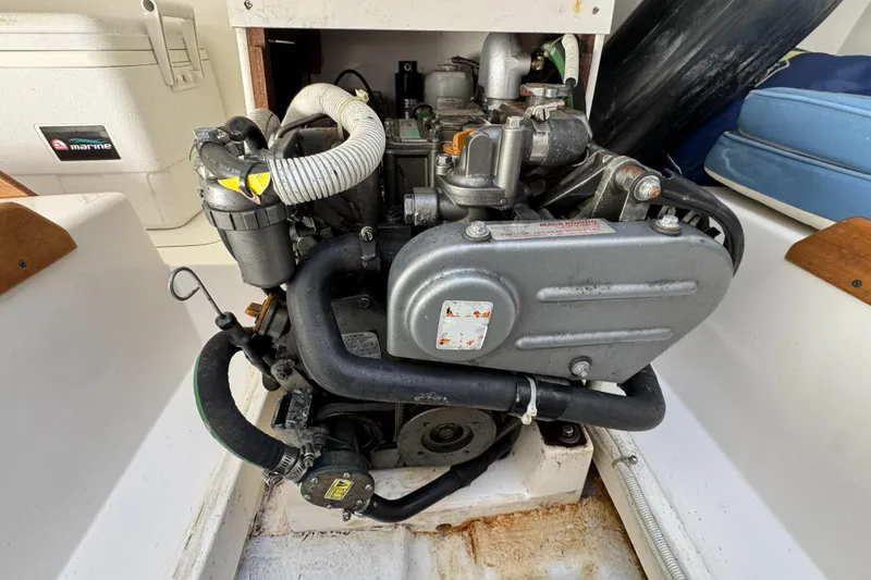 Slide: The Image of Engine compartment of a 2011 J Boats J/95 sailboat, showcasing mechanical components. - 28