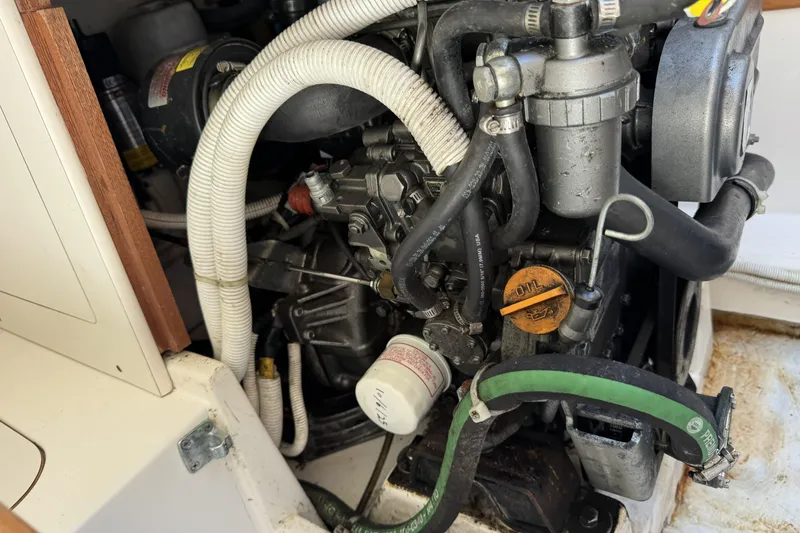 Slide: The Image of Engine compartment of a 2011 J Boats J/95 sailboat, showcasing hoses and mechanical components. - 30