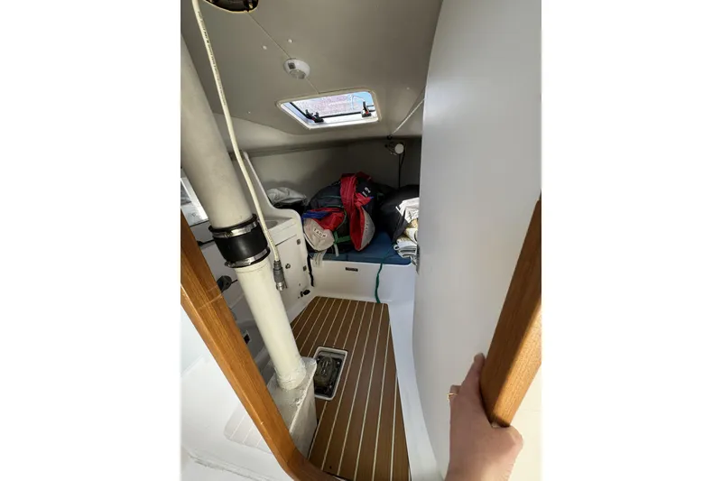 Slide: The Image of Interior cabin of 2011 J Boats J/95 sailboat with wooden flooring and storage. - 31