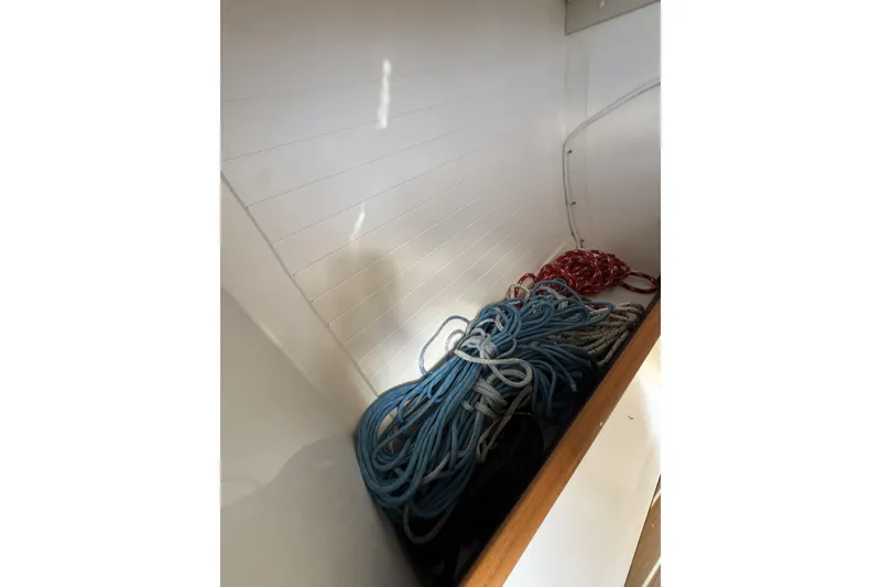 Slide: The Image of Coiled ropes inside a 2011 J Boats J/95 sailboat storage compartment. - 32
