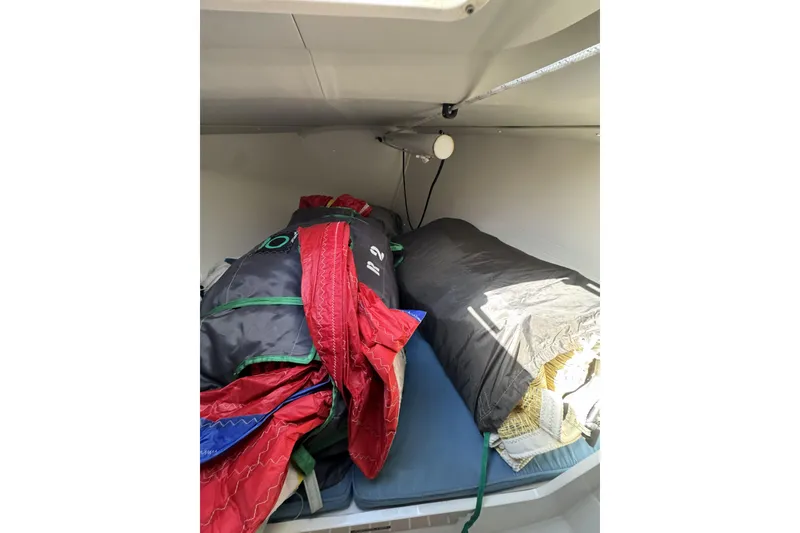 Slide: The Image of Interior cabin of 2011 J Boats J/95 with sails and equipment stored. - 35