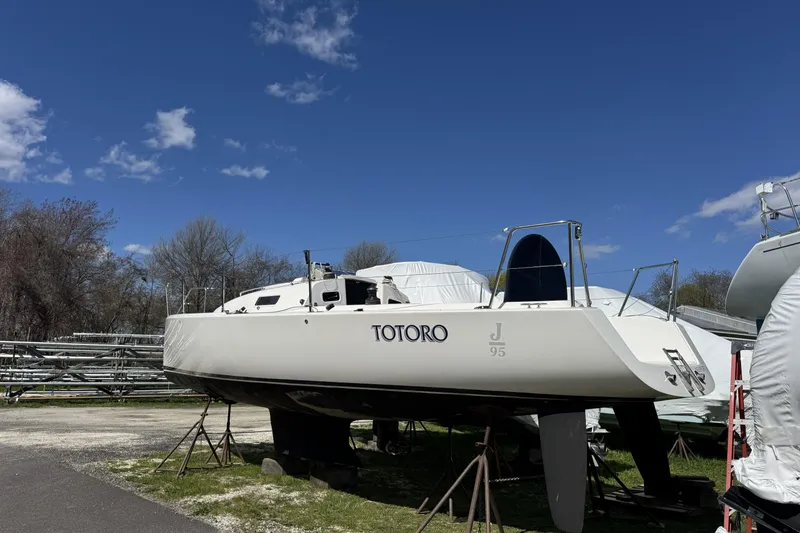 Slide: The Image of 2011 J Boats J/95 sailboat on stands under a clear blue sky. - 7