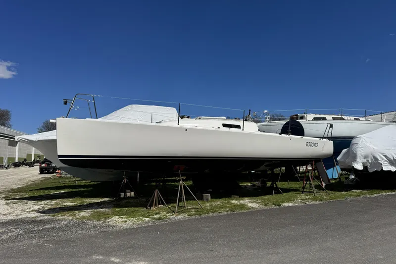 Slide: The Image of 2011 J Boats J/95 sailboat on stands, clear blue sky background. - 8