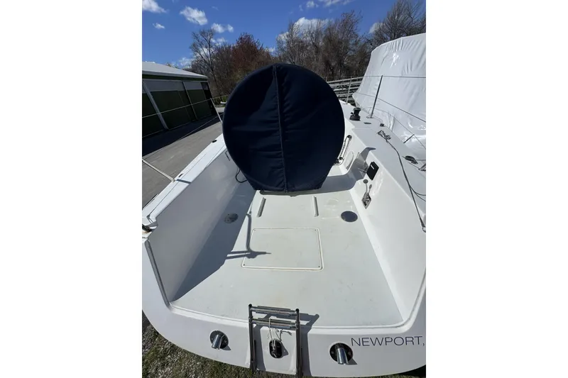 Slide: The Image of 2011 J Boats J/95 sailboat cockpit with covered wheel, docked under clear sky. - 9