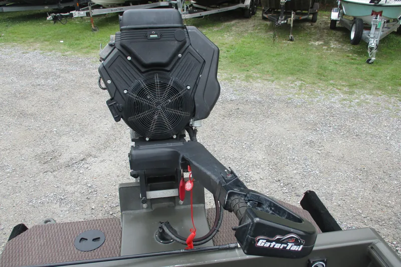 Slide: The Image of 2024 Gator Tail 1848 Gator Series boat motor, outdoor setting, gravel and grass background. - 4